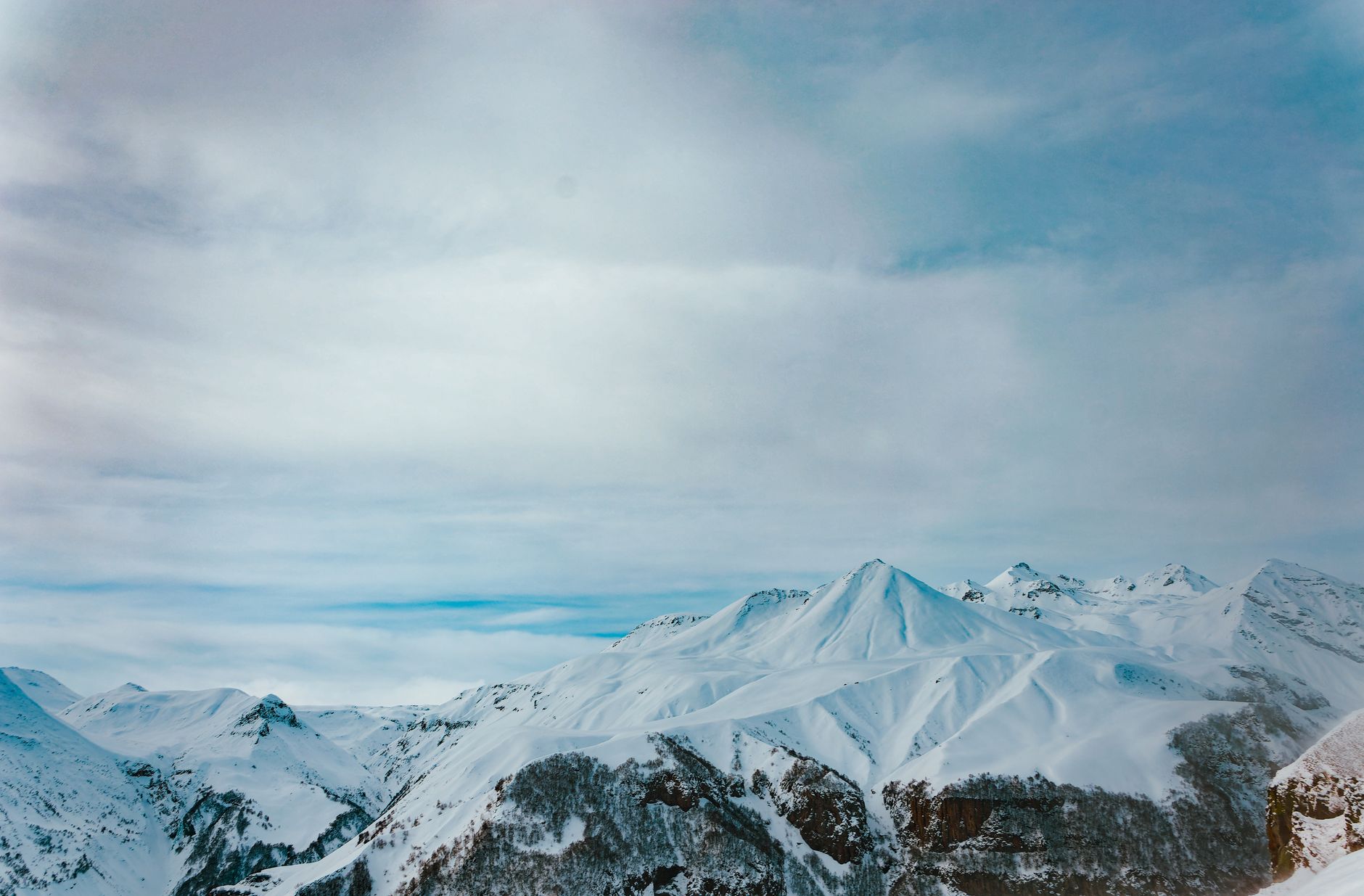 Snow-covered mountain peaks under a clear blue sky